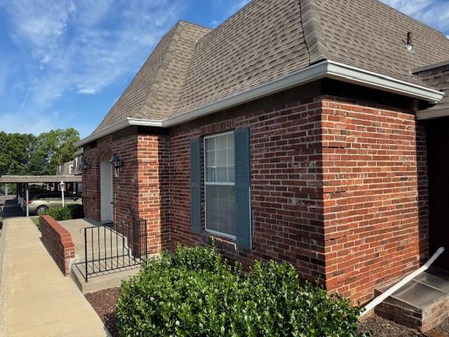 5737 Metcalf Ct, Overland Park, KS 66202 - view of side of property featuring brick siding and a shingled roof