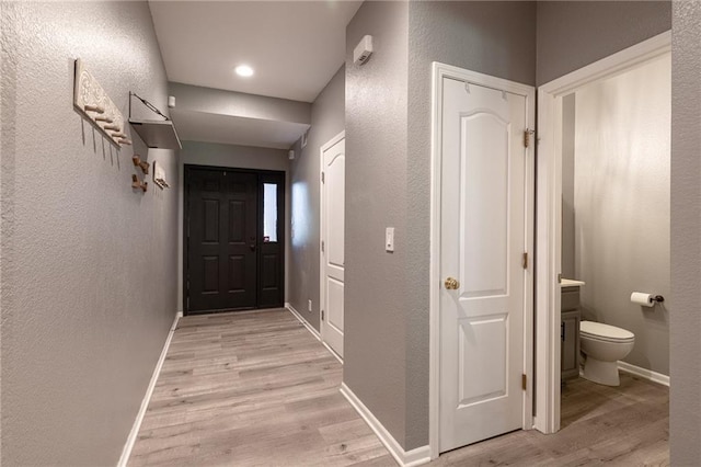 632 SW Shadow Glen Ct, Blue Springs, MO 64015 - corridor featuring a textured wall and light wood-style flooring