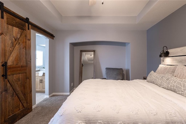 632 SW Shadow Glen Ct, Blue Springs, MO 64015 - bedroom featuring a barn door, carpet, a raised ceiling, and ensuite bath