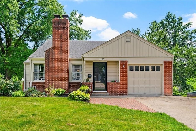 1115 W 26th St S, Independence, MO 64052 - view of front of property featuring driveway, a chimney, brick siding, and an attached garage