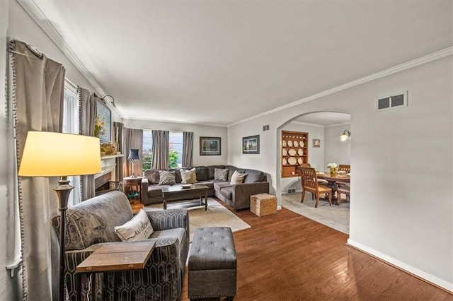 1115 W 26th St S, Independence, MO 64052 - living room with arched walkways, ornamental molding, and wood finished floors