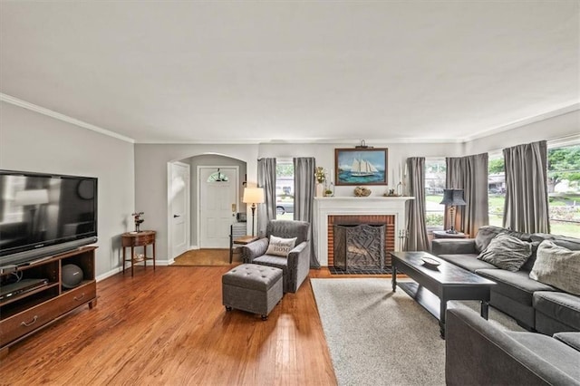 1115 W 26th St S, Independence, MO 64052 - living area with arched walkways, wood finished floors, ornamental molding, and a fireplace