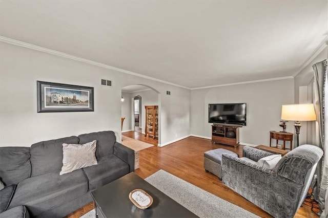 1115 W 26th St S, Independence, MO 64052 - living room with arched walkways, ornamental molding, and wood finished floors