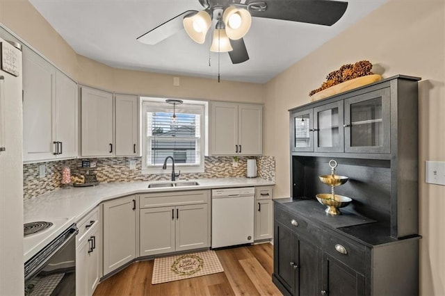 1115 W 26th St S, Independence, MO 64052 - kitchen with white appliances, a ceiling fan, light wood-style floors, decorative backsplash, and light countertops