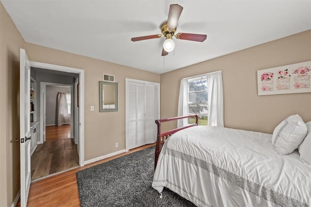 1115 W 26th St S, Independence, MO 64052 - bedroom with wood finished floors, a closet, and ceiling fan