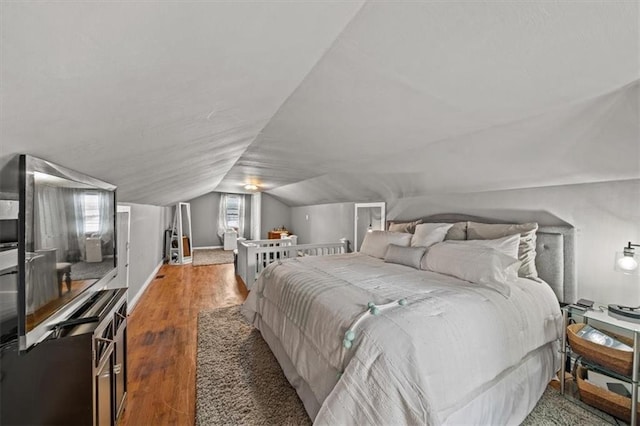 1115 W 26th St S, Independence, MO 64052 - bedroom with lofted ceiling and wood finished floors