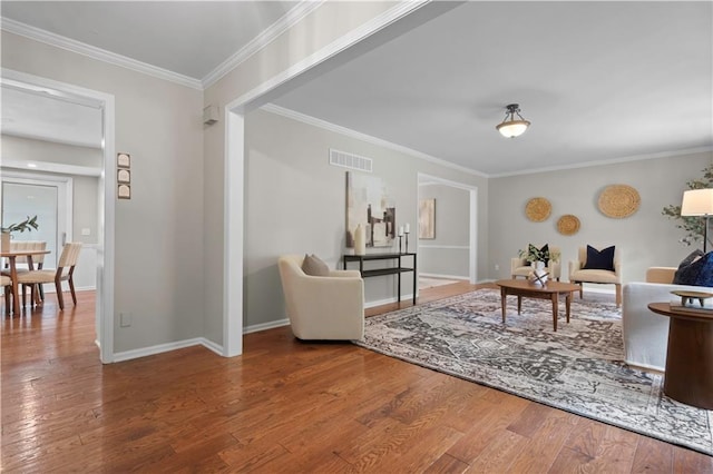 7710 Noland Rd, Lenexa, KS 66216 - living area with wood finished floors and ornamental molding