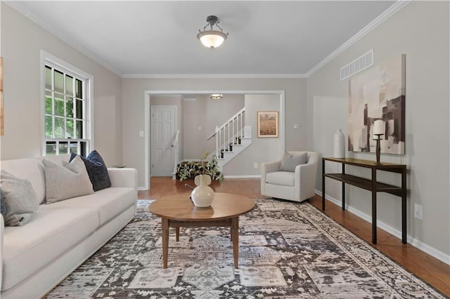 7710 Noland Rd, Lenexa, KS 66216 - living room featuring ornamental molding, stairs, and wood finished floors