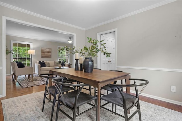 7710 Noland Rd, Lenexa, KS 66216 - dining area featuring wood finished floors and crown molding