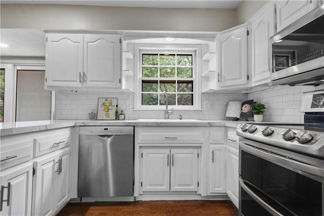 7710 Noland Rd, Lenexa, KS 66216 - kitchen with stainless steel appliances, open shelves, white cabinets, and tasteful backsplash