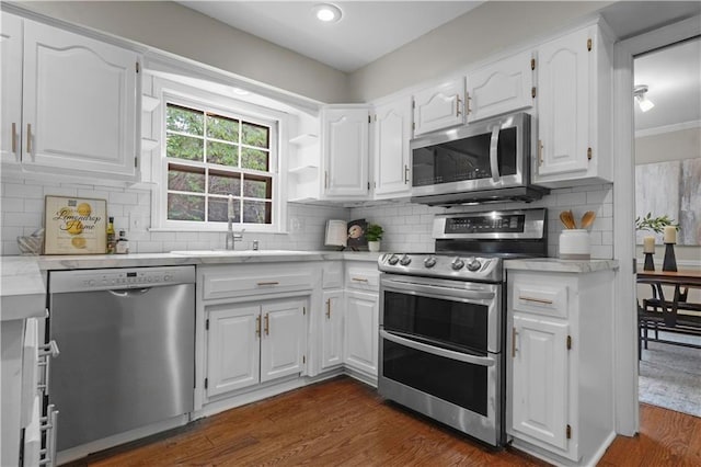 7710 Noland Rd, Lenexa, KS 66216 - kitchen with appliances with stainless steel finishes, white cabinetry, light countertops, backsplash, and recessed lighting