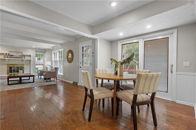 7710 Noland Rd, Lenexa, KS 66216 - dining space featuring hardwood / wood-style flooring, beam ceiling, a fireplace, and recessed lighting