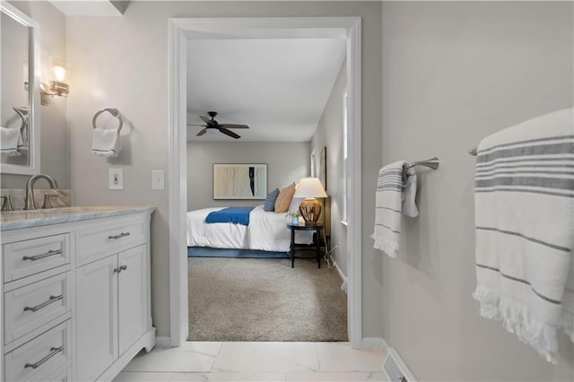 7710 Noland Rd, Lenexa, KS 66216 - ensuite bathroom with vanity, ceiling fan, and marble finish flooring