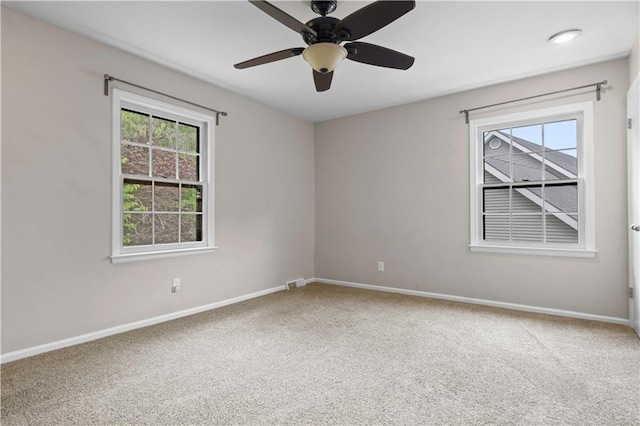 7710 Noland Rd, Lenexa, KS 66216 - unfurnished room featuring carpet flooring, healthy amount of natural light, and a ceiling fan