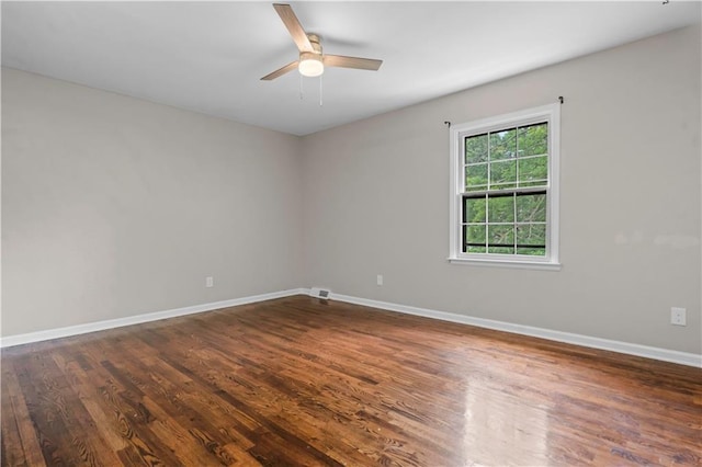 7710 Noland Rd, Lenexa, KS 66216 - empty room featuring a ceiling fan and dark wood finished floors