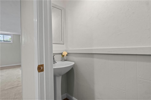 7710 Noland Rd, Lenexa, KS 66216 - bathroom with baseboards and a sink