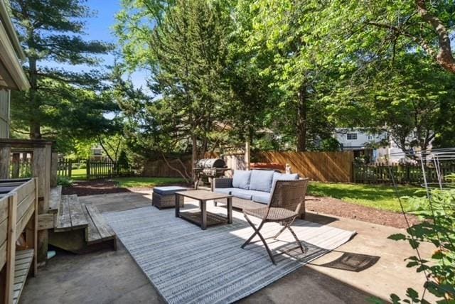 7710 Noland Rd, Lenexa, KS 66216 - fenced backyard featuring outdoor lounge area, a deck, and area for grilling