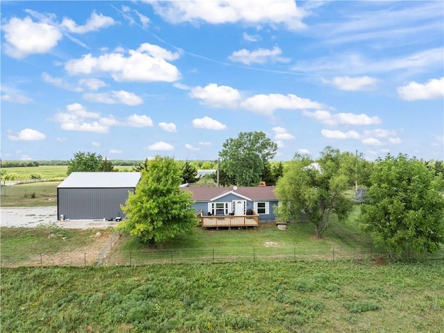 679 Kingman Rd, Pomona, KS 66076 - rear view of house featuring a lawn, a deck, and a rural view