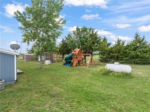 679 Kingman Rd, Pomona, KS 66076 - view of yard with a playground and an outbuilding