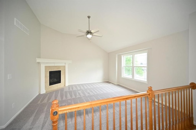 12905 Ridgeview Dr, Platte City, MO 64079 - unfurnished living room with carpet, ceiling fan, vaulted ceiling, and a tile fireplace