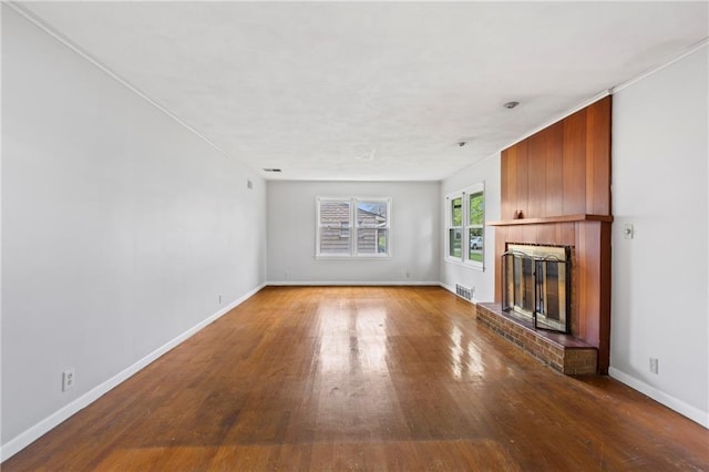 2111 Lombardy Dr, Kansas City, KS 66102 - unfurnished living room with a glass covered fireplace and wood finished floors