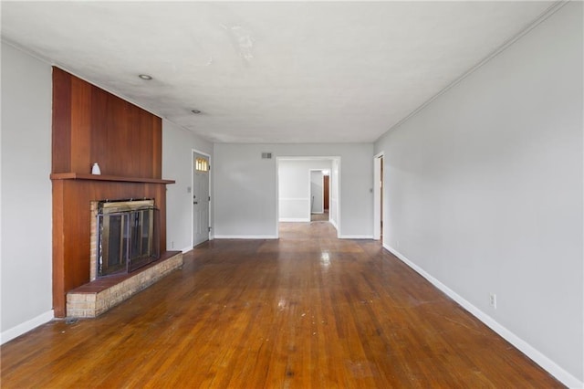 2111 Lombardy Dr, Kansas City, KS 66102 - unfurnished living room featuring a fireplace and hardwood / wood-style flooring