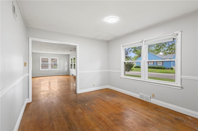 2111 Lombardy Dr, Kansas City, KS 66102 - spare room with wood-type flooring, healthy amount of natural light, and crown molding