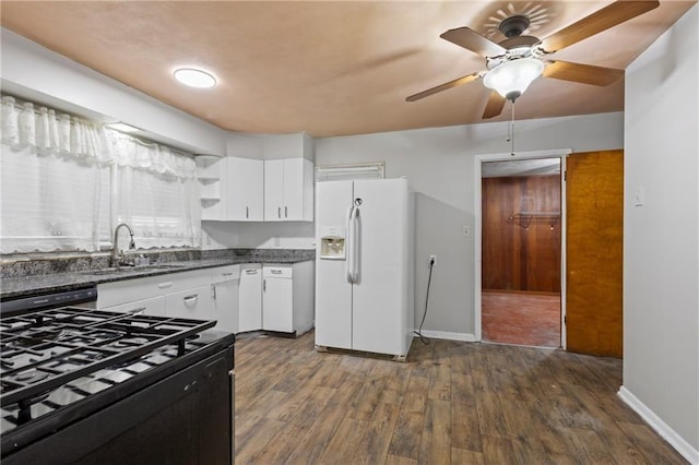 2111 Lombardy Dr, Kansas City, KS 66102 - kitchen with black gas stove, white refrigerator with ice dispenser, dishwasher, white cabinets, and dark wood-style flooring