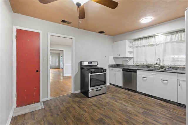 2111 Lombardy Dr, Kansas City, KS 66102 - kitchen featuring appliances with stainless steel finishes, dark countertops, dark wood-style flooring, and a ceiling fan