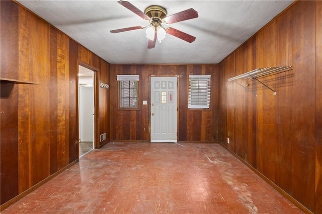 2111 Lombardy Dr, Kansas City, KS 66102 - entryway featuring wood walls, a ceiling fan, and tile patterned floors