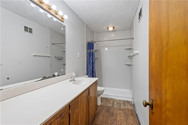2111 Lombardy Dr, Kansas City, KS 66102 - bathroom featuring curtained shower, vanity, and wood finished floors