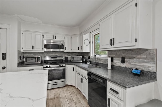 15320 W 92nd Pl, Lenexa, KS 66219 - kitchen with stainless steel appliances, white cabinets, backsplash, light wood-type flooring, and ornamental molding