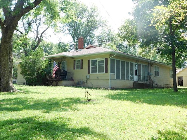 123 E Allison St, Nevada, MO 64772 - back of property featuring a chimney and a yard