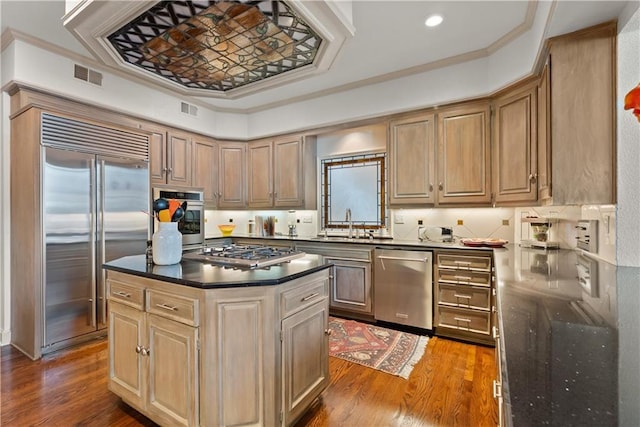 5212 W 98th Ter, Overland Park, KS 66207 - kitchen featuring appliances with stainless steel finishes, dark wood-style flooring, a center island, ornamental molding, and recessed lighting