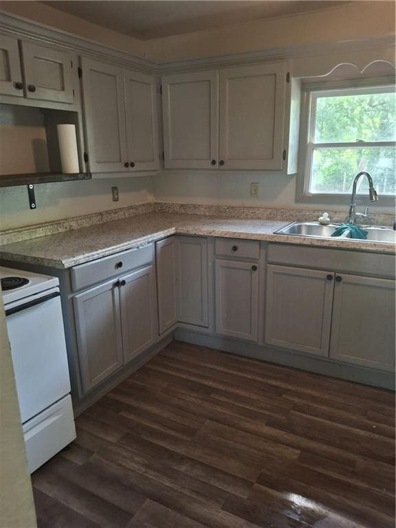 608 N Cedar St, Ottawa, KS 66067 - kitchen featuring white electric stove, dark wood-style floors, light countertops, and gray cabinets