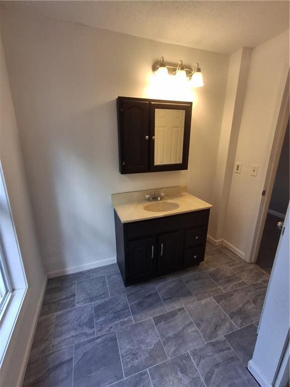 608 N Cedar St, Ottawa, KS 66067 - bathroom with vanity and stone finish floors