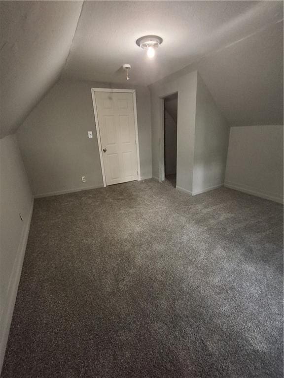 608 N Cedar St, Ottawa, KS 66067 - additional living space featuring lofted ceiling and carpet
