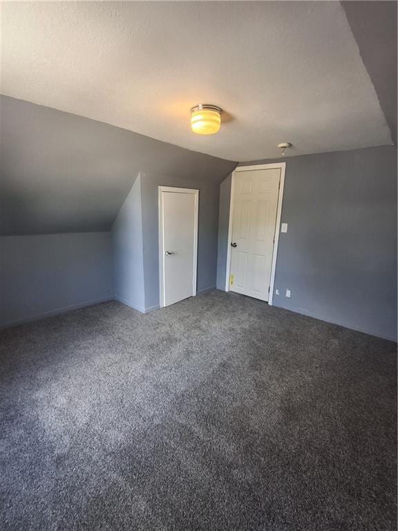 608 N Cedar St, Ottawa, KS 66067 - additional living space with carpet and vaulted ceiling