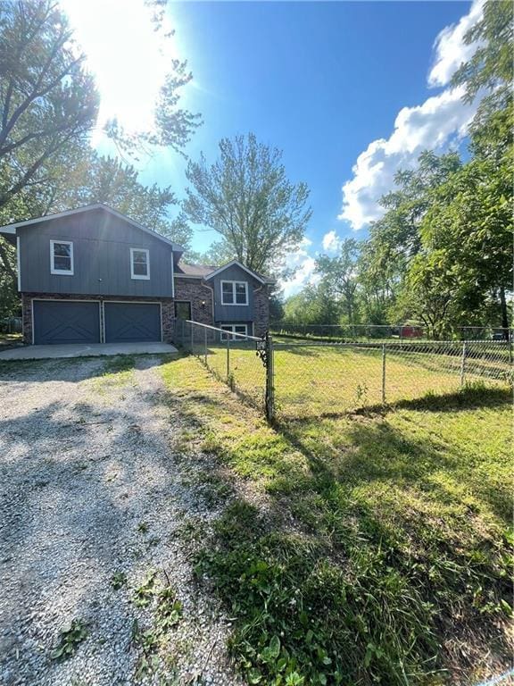 14948 Lakeside Dr, Excelsior Springs, MO 64024 - view of yard featuring a garage and driveway