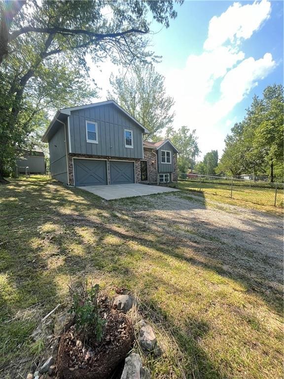 14948 Lakeside Dr, Excelsior Springs, MO 64024 - view of yard featuring a garage and driveway