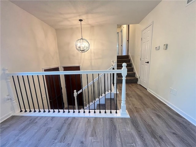 14948 Lakeside Dr, Excelsior Springs, MO 64024 - stairs featuring wood finished floors and a chandelier