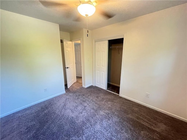 14948 Lakeside Dr, Excelsior Springs, MO 64024 - unfurnished bedroom with dark carpet, a closet, ceiling fan, and a textured ceiling