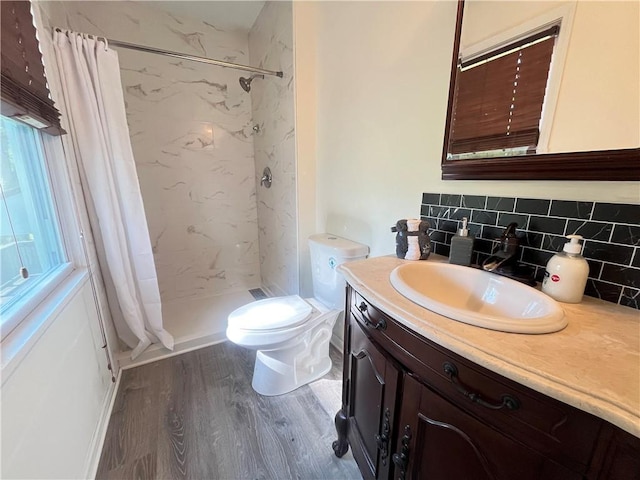 14948 Lakeside Dr, Excelsior Springs, MO 64024 - full bath with vanity, tasteful backsplash, a shower stall, and wood finished floors