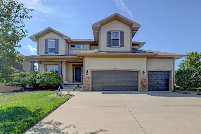 10963 S Carbondale St, Olathe, KS 66061 - view of front of house with stucco siding, driveway, a front lawn, and a garage