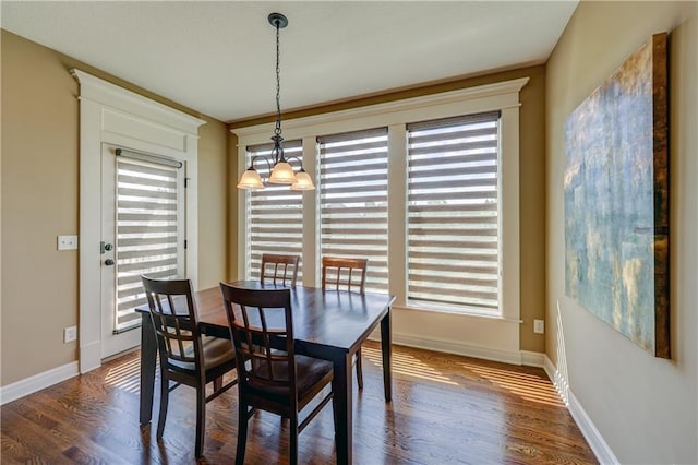 10963 S Carbondale St, Olathe, KS 66061 - dining space with healthy amount of natural light, wood finished floors, and a chandelier