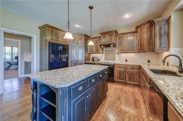 10963 S Carbondale St, Olathe, KS 66061 - kitchen featuring black appliances, under cabinet range hood, open shelves, light wood-style flooring, and a center island