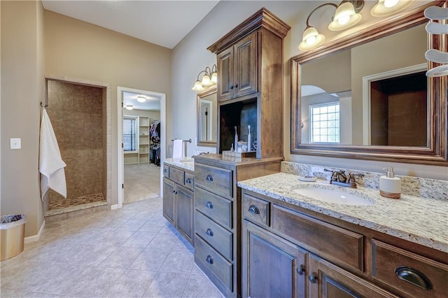 10963 S Carbondale St, Olathe, KS 66061 - bathroom featuring vanity, a shower stall, tile patterned flooring, and a spacious closet