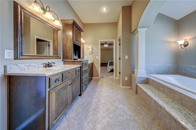 10963 S Carbondale St, Olathe, KS 66061 - full bathroom with decorative columns, vanity, a garden tub, a ceiling fan, and ensuite bath