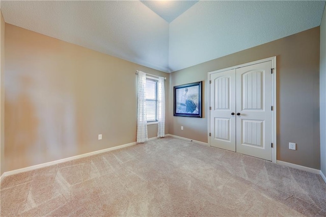 10963 S Carbondale St, Olathe, KS 66061 - unfurnished bedroom with carpet floors, a closet, vaulted ceiling, and a textured ceiling