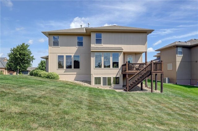 10963 S Carbondale St, Olathe, KS 66061 - rear view of property featuring stairway, a wooden deck, and a lawn